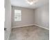 Well-lit bedroom featuring neutral walls, tile floors, ceiling fan, and a window at 7987 Sw 89Th Cir, Ocala, FL 34481