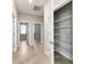 Bright hallway with neutral paint, tile flooring, and a glimpse into other rooms and a pantry at 7987 Sw 89Th Cir, Ocala, FL 34481