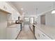 Open kitchen with stainless steel appliances, white cabinets, and a large island perfect for entertaining at 7987 Sw 89Th Cir, Ocala, FL 34481
