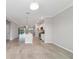 Open-concept kitchen and living area boasts modern appliances, granite countertops, and tile flooring at 7987 Sw 89Th Cir, Ocala, FL 34481