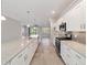 Beautiful kitchen with stainless appliances, white cabinets, quartz countertops, and a large island at 7987 Sw 89Th Cir, Ocala, FL 34481