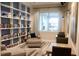 Inviting library space with a large bookcase, comfortable seating, and a view of the outdoors at 7987 Sw 89Th Cir, Ocala, FL 34481