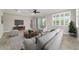 Staged living room featuring tile flooring, comfortable seating, and a large window for natural light at 7987 Sw 89Th Cir, Ocala, FL 34481