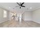 Spacious living area showcasing tile flooring, recessed lighting, and an open layout connecting to the kitchen at 7987 Sw 89Th Cir, Ocala, FL 34481