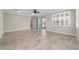 Large living room with tile floors, a ceiling fan, and sliding glass doors leading to an outdoor space at 7987 Sw 89Th Cir, Ocala, FL 34481