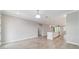 Spacious living area showcasing tile flooring, neutral paint, and seamless flow into the kitchen and dining area at 7987 Sw 89Th Cir, Ocala, FL 34481
