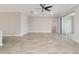 Expansive living area showcasing tile floors, a modern ceiling fan, and sliding doors for indoor-outdoor living at 7987 Sw 89Th Cir, Ocala, FL 34481
