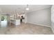 Bright, open-concept living space featuring tile floors and seamless flow into the kitchen and dining area at 7987 Sw 89Th Cir, Ocala, FL 34481