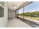 Screened in patio featuring a ceiling fan, brick flooring and a view of the fenced backyard at 7987 Sw 89Th Cir, Ocala, FL 34481