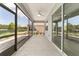 Screened in patio with an overhead ceiling fan and views of backyard at 7987 Sw 89Th Cir, Ocala, FL 34481