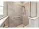 Walk-in shower with tile surround, glass enclosure, and built-in seating at 7987 Sw 89Th Cir, Ocala, FL 34481