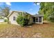 Back of house with screened in porch and lush landscaping at 8137 Sw 117Th Loop, Ocala, FL 34481