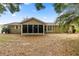 View of the back of a house with a screened in porch at 8137 Sw 117Th Loop, Ocala, FL 34481