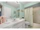 Bathroom featuring a shower-tub combo, tiled walls, and a single sink vanity at 8137 Sw 117Th Loop, Ocala, FL 34481