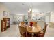 Open-concept dining area with tile flooring, connecting to the living room and kitchen at 8137 Sw 117Th Loop, Ocala, FL 34481