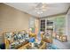 Bright Florida room featuring comfortable seating, sliding glass door, and a ceiling fan at 8137 Sw 117Th Loop, Ocala, FL 34481