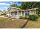 Inviting single-story home showcasing a quaint front porch and manicured flowerbeds at 8137 Sw 117Th Loop, Ocala, FL 34481
