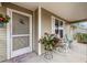 Cozy front porch adorned with rocking chairs and floral accents, perfect for relaxing outdoors at 8137 Sw 117Th Loop, Ocala, FL 34481