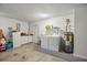 Spacious garage with laundry area, shelving, water heater, and extra storage cabinets at 8137 Sw 117Th Loop, Ocala, FL 34481