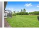 Expansive backyard featuring lush green grass, a screened-in patio, and privacy landscaping at 8809 Sw 61St Loop, Ocala, FL 34481