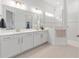 Elegant bathroom featuring double sinks, a large mirror, and a glass-enclosed shower at 8809 Sw 61St Loop, Ocala, FL 34481