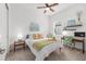 Bright bedroom features neutral carpet, a window, and a side table with a lamp at 8809 Sw 61St Loop, Ocala, FL 34481