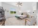Serene bedroom with a ceiling fan, large window, and comfortable seating at 8809 Sw 61St Loop, Ocala, FL 34481