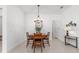 Dining area with wood table and chairs, illuminated by a stylish chandelier at 8809 Sw 61St Loop, Ocala, FL 34481