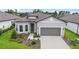 Single-story home showcasing well-manicured landscaping, a two-car garage, and a welcoming front entrance at 8809 Sw 61St Loop, Ocala, FL 34481