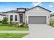 Charming single-story home showcasing well-manicured landscaping, a two-car garage, and a welcoming front entrance at 8809 Sw 61St Loop, Ocala, FL 34481