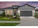 Charming single-story home showcasing well-manicured landscaping, a two-car garage, and a welcoming front entrance at 8809 Sw 61St Loop, Ocala, FL 34481