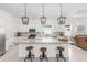 Bright kitchen featuring a large island with seating, pendant lights, and modern finishes at 8809 Sw 61St Loop, Ocala, FL 34481
