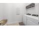 Functional laundry room with side-by-side washer and dryer, plus upper shelf storage at 8809 Sw 61St Loop, Ocala, FL 34481