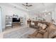 Bright, open living room with a large sectional sofa, modern decor, and neutral color palette at 8809 Sw 61St Loop, Ocala, FL 34481