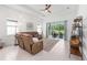 Spacious living room with a ceiling fan, neutral decor, and sliding glass doors to outdoor space at 8809 Sw 61St Loop, Ocala, FL 34481