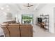 Inviting living room with comfortable seating, a ceiling fan, and access to the outdoor patio at 8809 Sw 61St Loop, Ocala, FL 34481