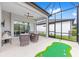 Relax on this patio with its putting green, ceiling fan, and comfortable wicker seating at 8809 Sw 61St Loop, Ocala, FL 34481