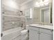 Bathroom featuring a shower-tub combination, white cabinets, and granite countertops at 9777 Sw 63Rd Loop, Ocala, FL 34481