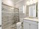 Bright bathroom featuring granite counters, white vanity and tiled shower at 9777 Sw 63Rd Loop, Ocala, FL 34481