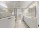 Bright bathroom showcasing double vanity sinks and a glass-enclosed shower at 9777 Sw 63Rd Loop, Ocala, FL 34481