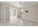 Bright bedroom with a ceiling fan, tile floor and adjacent to another room through glass doors at 9777 Sw 63Rd Loop, Ocala, FL 34481