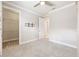 Neutral bedroom offering carpeted floors and a walk-in closet with shelving at 9777 Sw 63Rd Loop, Ocala, FL 34481