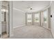 Bright bedroom with large windows, crown molding and neutral-toned carpet at 9777 Sw 63Rd Loop, Ocala, FL 34481