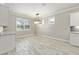 Bright dining area with modern chandelier, neutral walls, and stylish tiled floors at 9777 Sw 63Rd Loop, Ocala, FL 34481