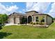Inviting home with manicured lawn, mature landscaping, stone accents and a spacious driveway leading to a two-car garage at 9777 Sw 63Rd Loop, Ocala, FL 34481