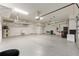 Spacious garage featuring epoxy flooring, utility sink, and ample storage at 9777 Sw 63Rd Loop, Ocala, FL 34481