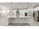 Beautiful kitchen featuring a large island with granite countertop, stainless appliances, and white cabinetry at 9777 Sw 63Rd Loop, Ocala, FL 34481