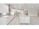 Modern kitchen with white cabinetry, granite countertops, stainless steel appliances, and a large island at 9777 Sw 63Rd Loop, Ocala, FL 34481