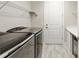 Laundry room featuring modern washer and dryer with sink and white cabinets at 9777 Sw 63Rd Loop, Ocala, FL 34481