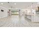 Open-concept living space featuring tile floors, neutral paint, recessed lighting, and seamless transition to an outdoor patio at 9777 Sw 63Rd Loop, Ocala, FL 34481